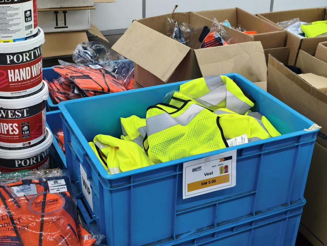Yellow reflective vests in a blue bin with an RM5.00 price sign