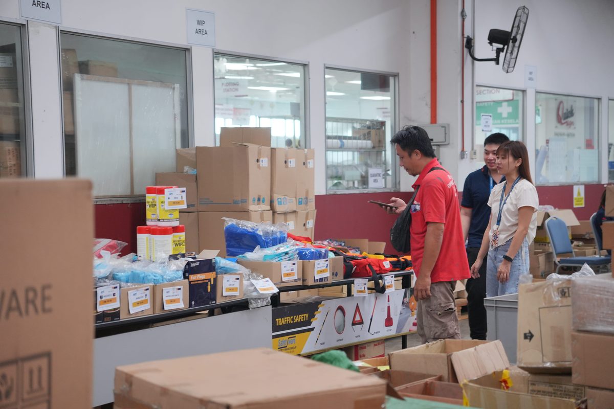 Visitors browsing PPE displays at the Safetyware Warehouse Sale in Penang